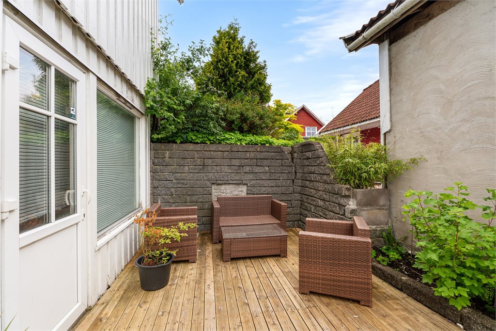 Skjermet uteplass med terrasse og egen sone for sittegruppe